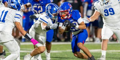 Los Altos running back fights through Chino defenders during a Hacienda League football game
