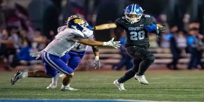 Chino running back Hugo Vlillasenor stiff-arms a Diamond Bar defender during the Cowboys’ 42–9 Senior Night win.